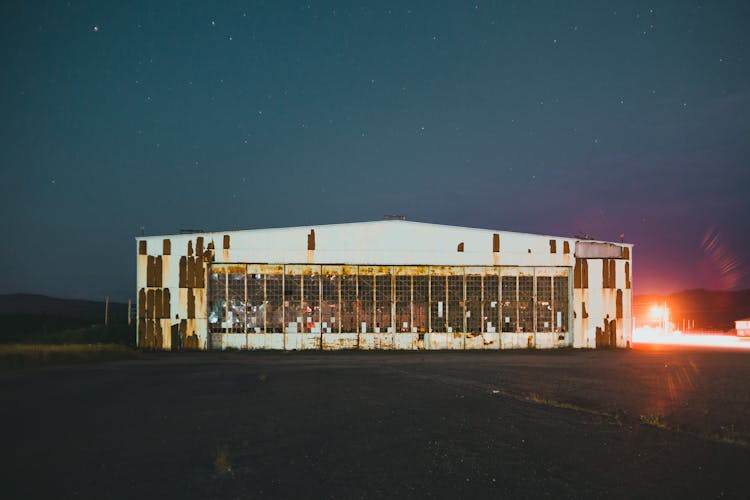 Light Near Abandoned Warehouse Building At Night