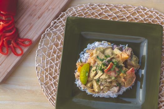 Delicious curry served on rice with fresh herbs, perfect for dinner.