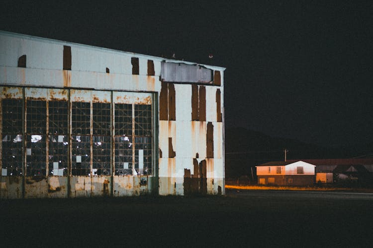 Photo Of Rusted Warehouse At Night