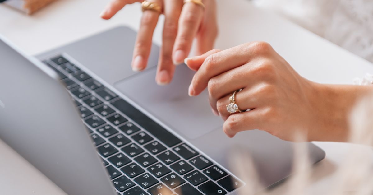 A Person with Rings Typing on a Laptop · Free Stock Photo