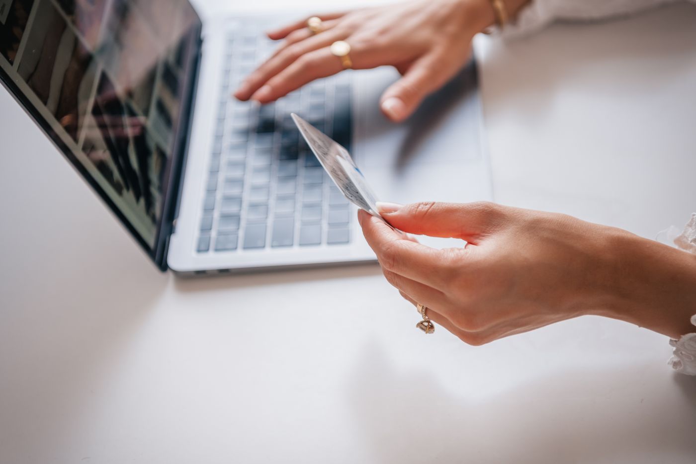 Customer using a laptop and payment card during an online purchase