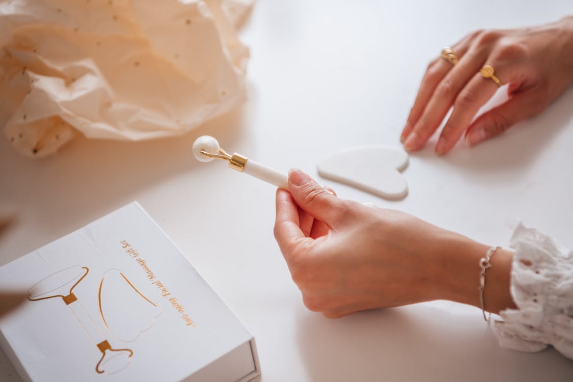 Free Person Holding a White Jade Roller Stock Photo