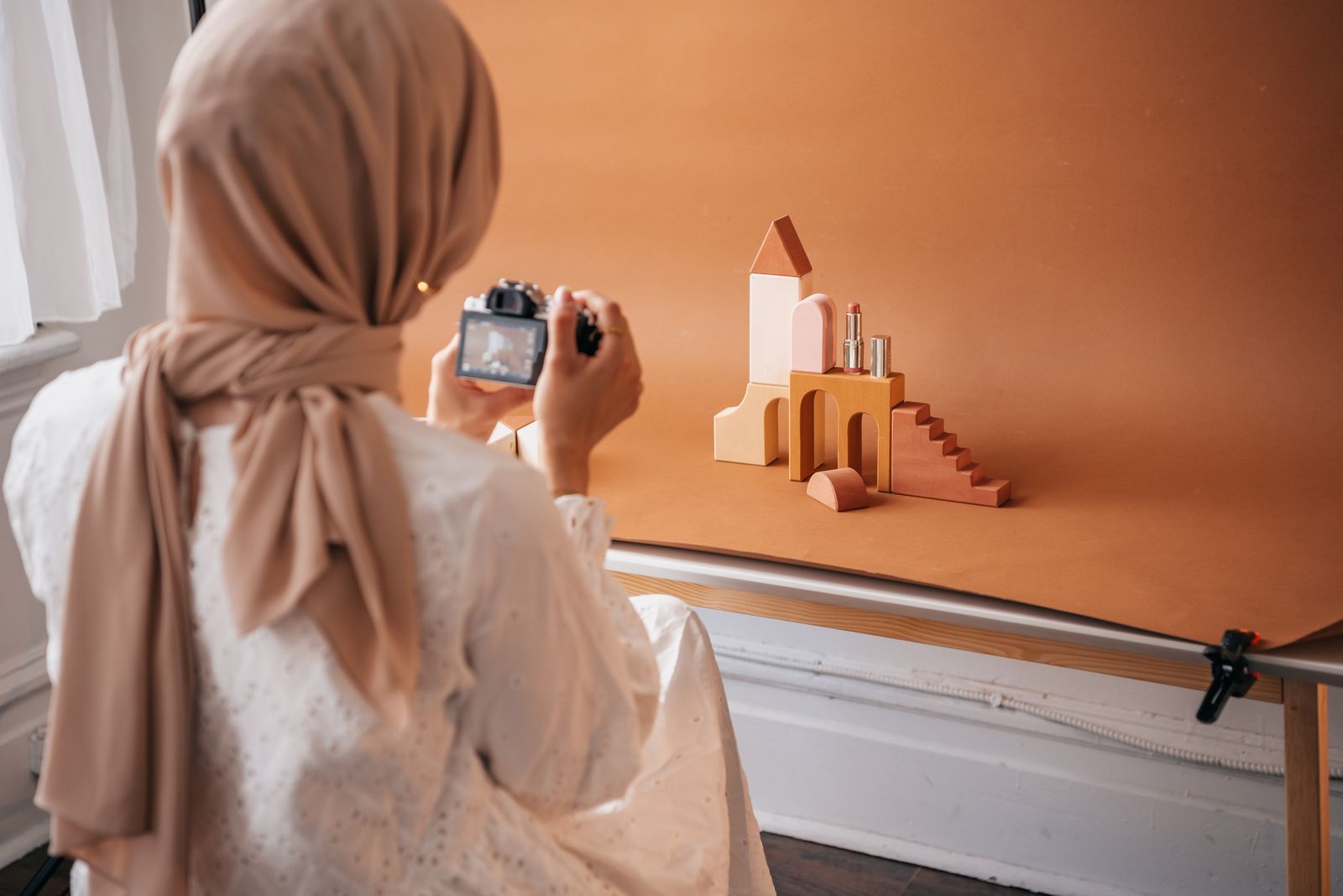 Photographer creating beauty product imagery in a studio