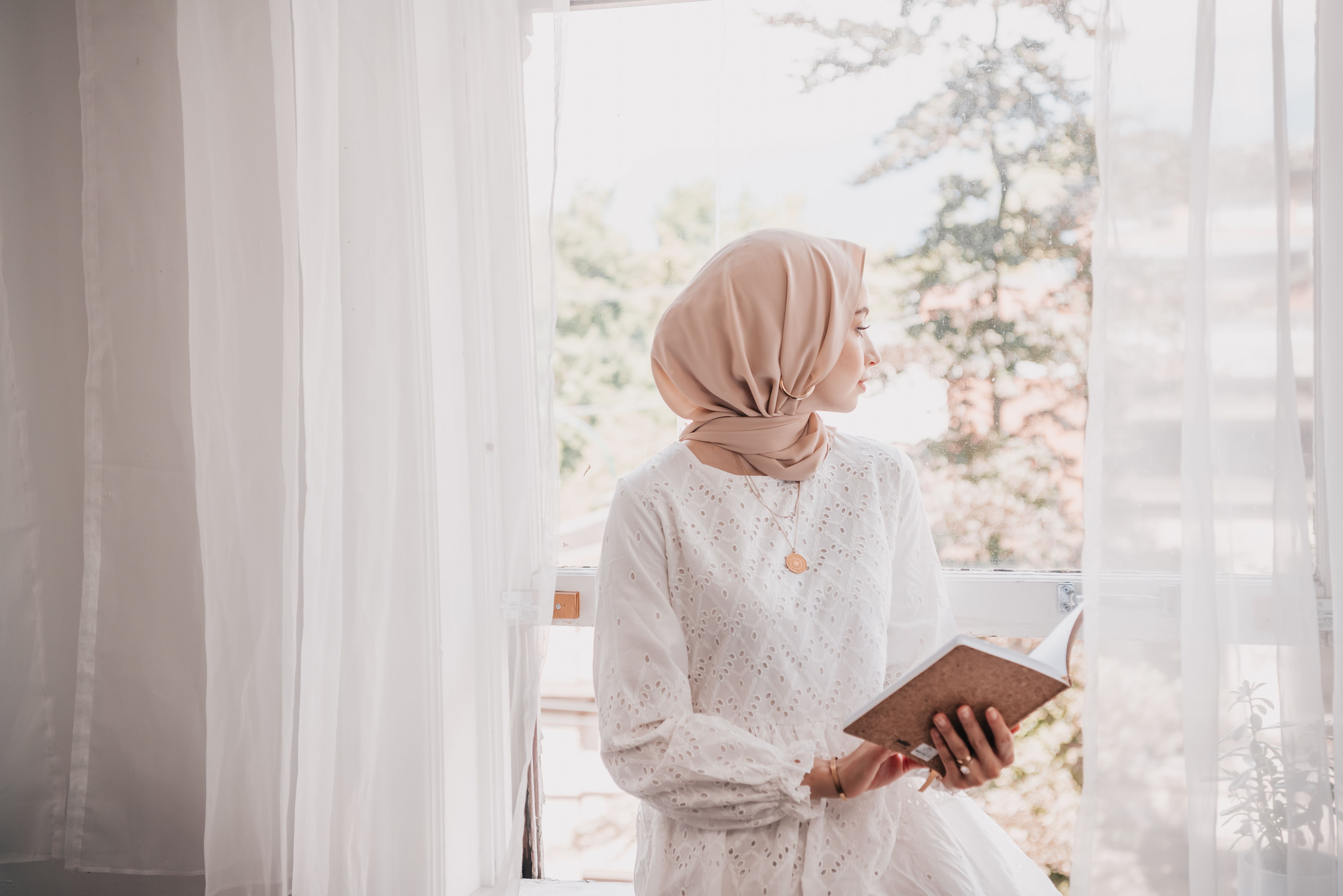Woman Wearing Hijab Holding a Notebook · Free Stock Photo