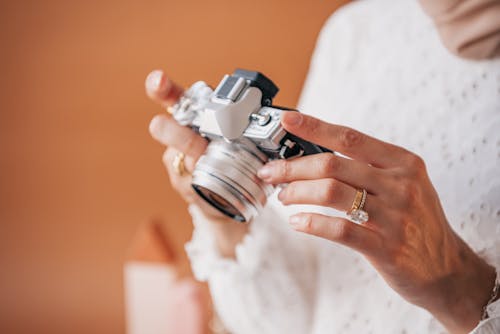 Person Holding Silver and Black Camera