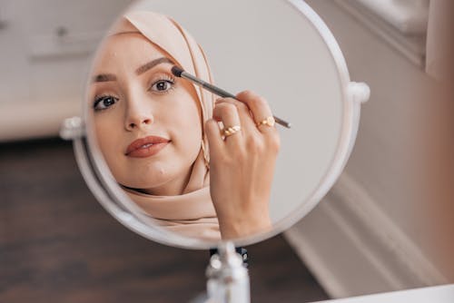 Free Woman Applying Makeup on Her Face Stock Photo