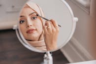 Woman Applying Makeup on Her Face