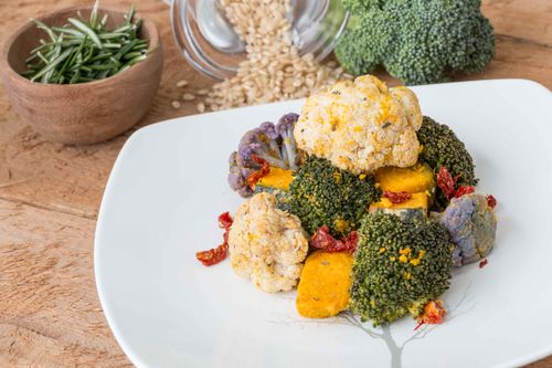 Free Delicious vegetarian dish featuring broccoli, cauliflower, and tofu garnished with herbs and spices. Stock Photo