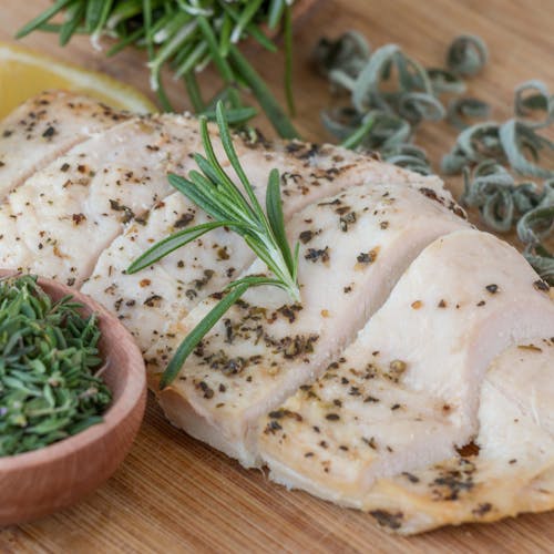 Cooked Chicken Meat with Rosemary Garnish