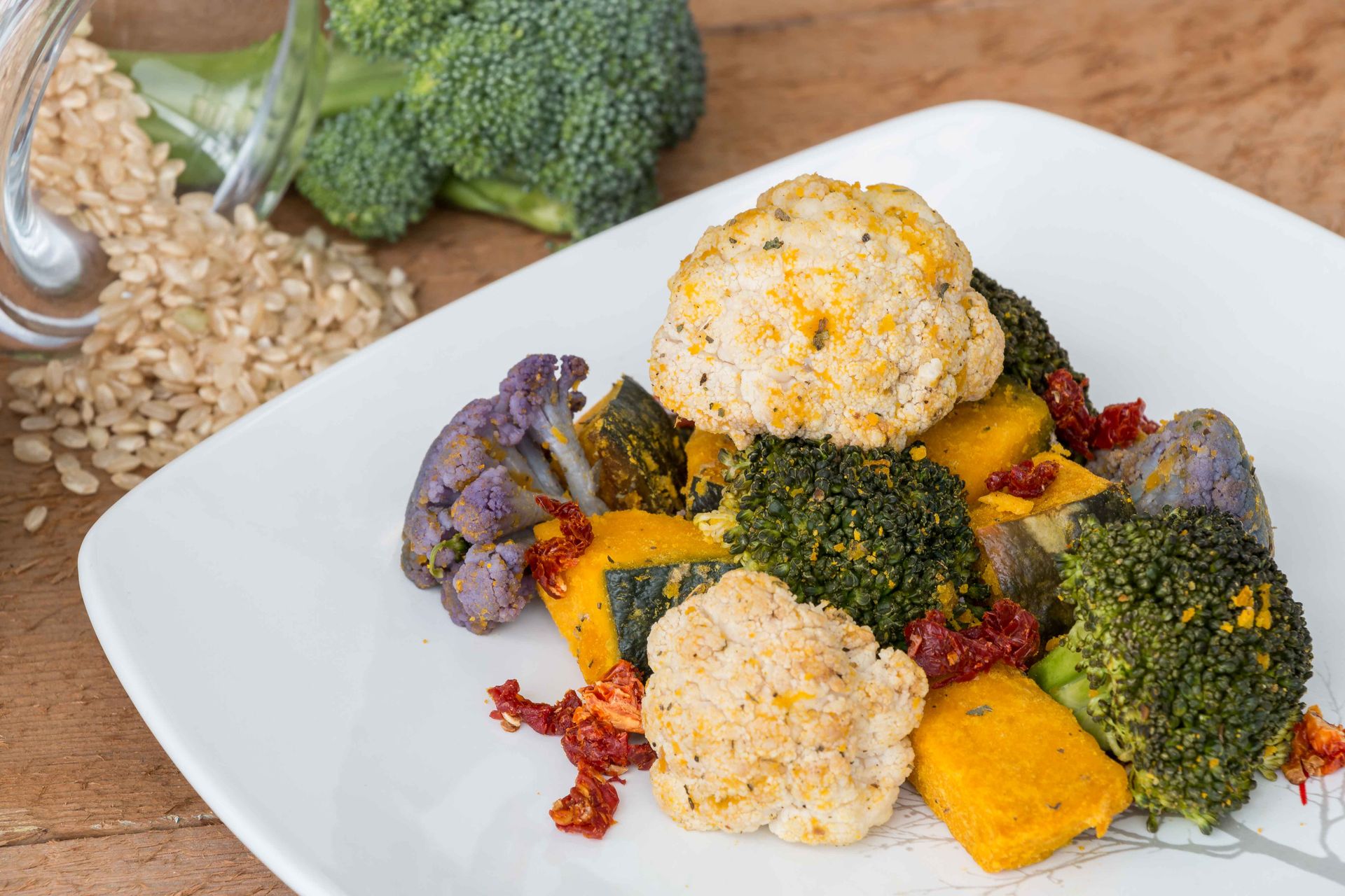 A healthy vegetarian dish featuring broccoli, cauliflower, and squash on a plate.