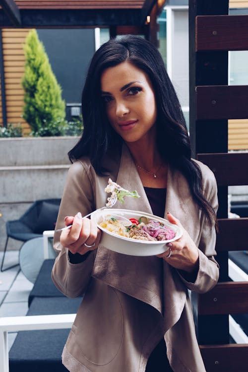 Beautiful Brunette Eating Meal Out