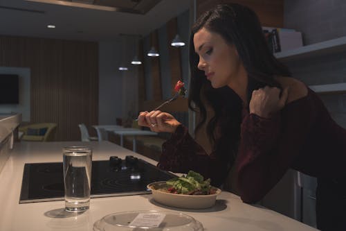 Brunette Woman Eating Salad