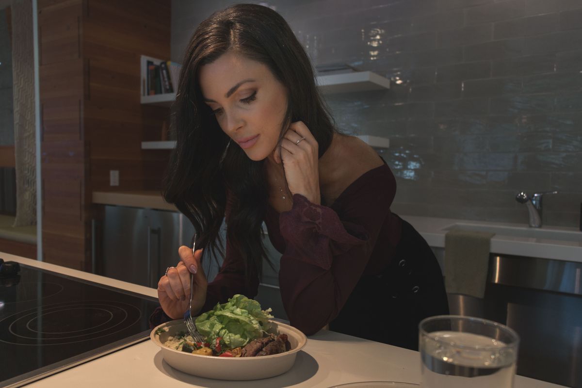 Woman eating a colourful balanced meal at home