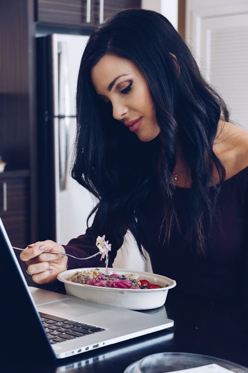 Woman Eating with a Fork