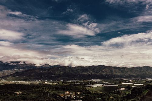 Free Breathtaking view of mountains under an expansive blue sky with clouds. Stock Photo