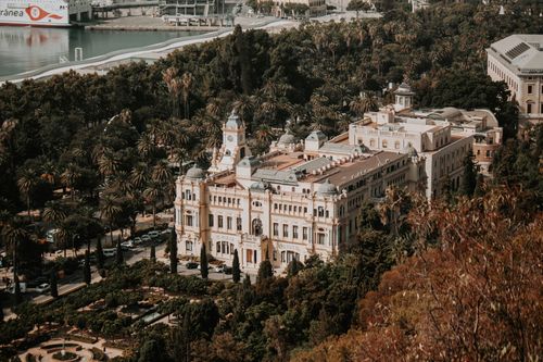 Free Captivating aerial view of the historic city council building amidst lush greenery in Malaga, Spain. Stock Photo