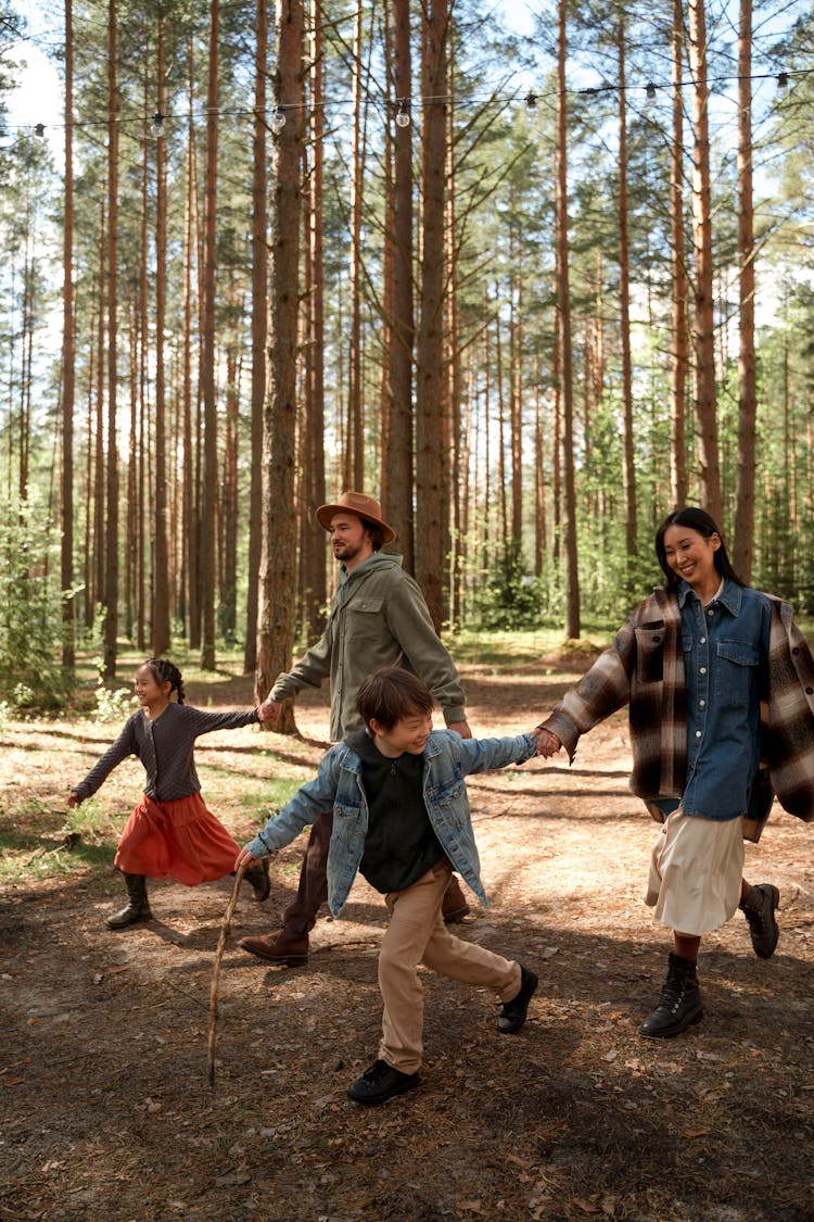 A Family Walking In The Forest