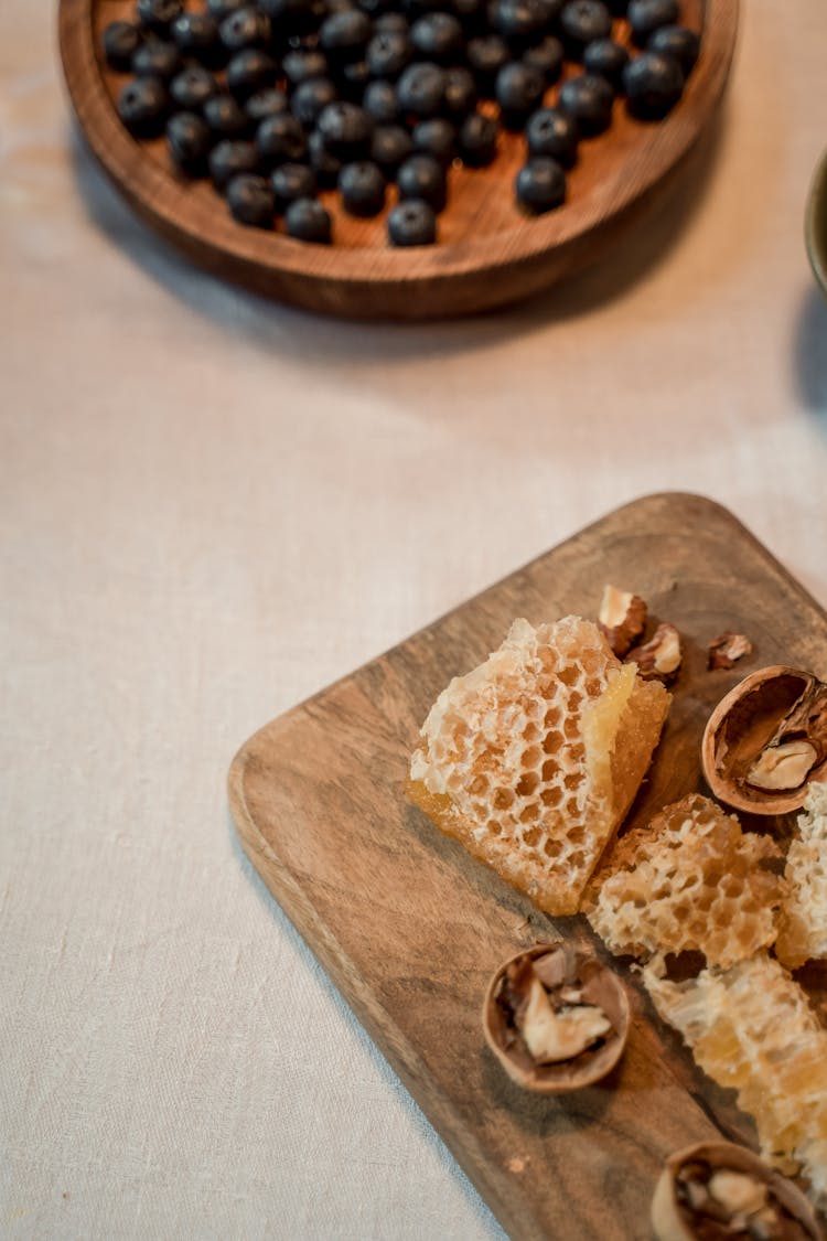 Nuts And Berries On Wooden Board