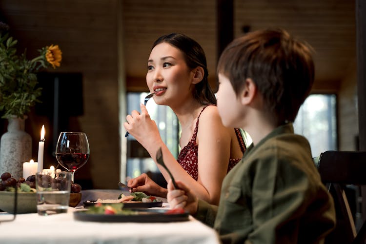 A Woman And Boy Eating Together 