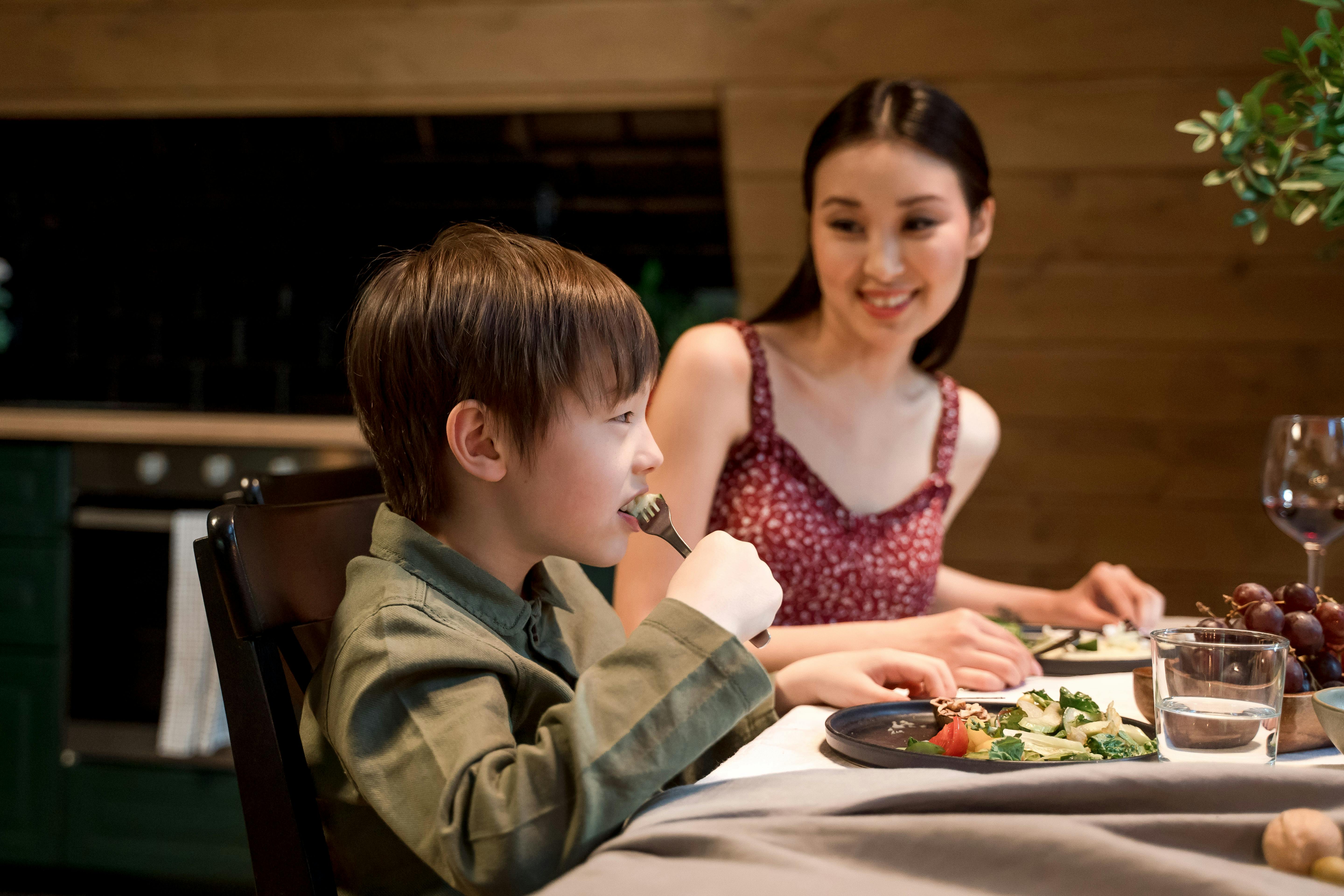 A Young Boy Eating Vegetable Salad