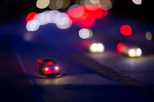 Free A vibrant night scene showcasing miniature cars with colorful bokeh lights on the road. Stock Photo