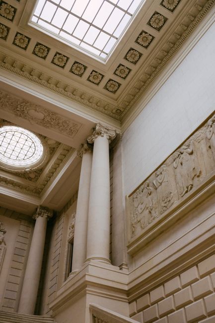 Ornate interior of a museum with classical architecture and detailed carvings.