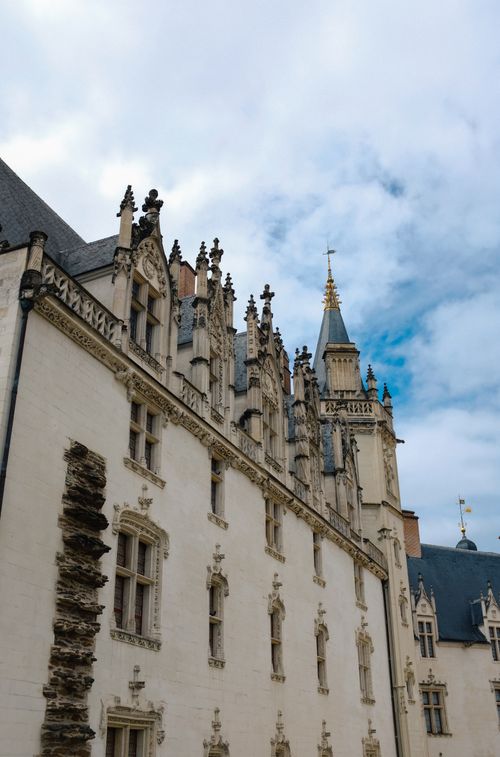 Free Stunning medieval architecture of the Château des Ducs de Bretagne in Nantes under a blue sky. Stock Photo