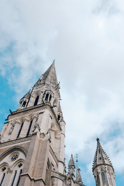 Free Majestic gothic architecture of a church tower reaching towards the sky, perfect for architectural enthusiasts. Stock Photo
