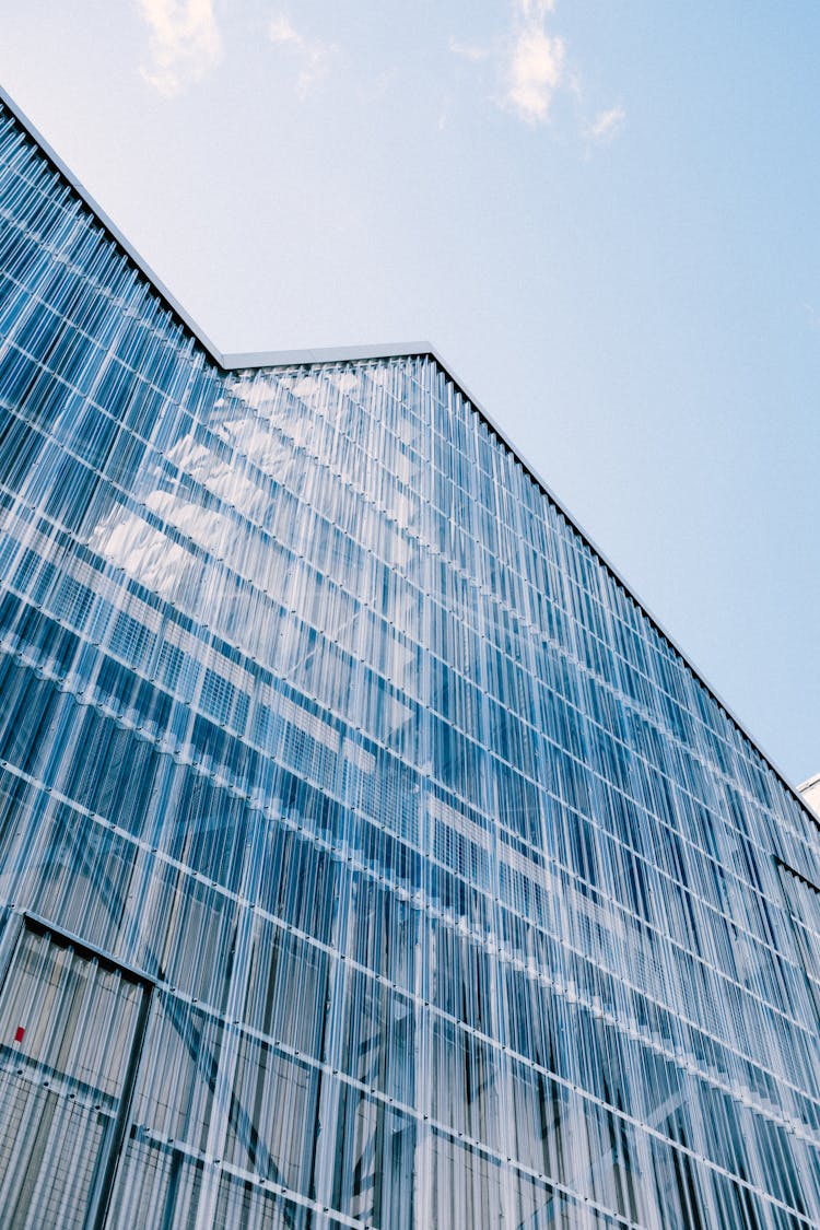 Modern Glass Futuristic Building On Blue Sky