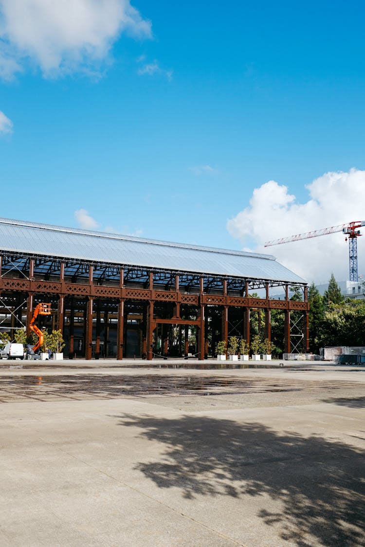 Exterior Of A Factory Warehouse With Concrete Pavement In Open Space