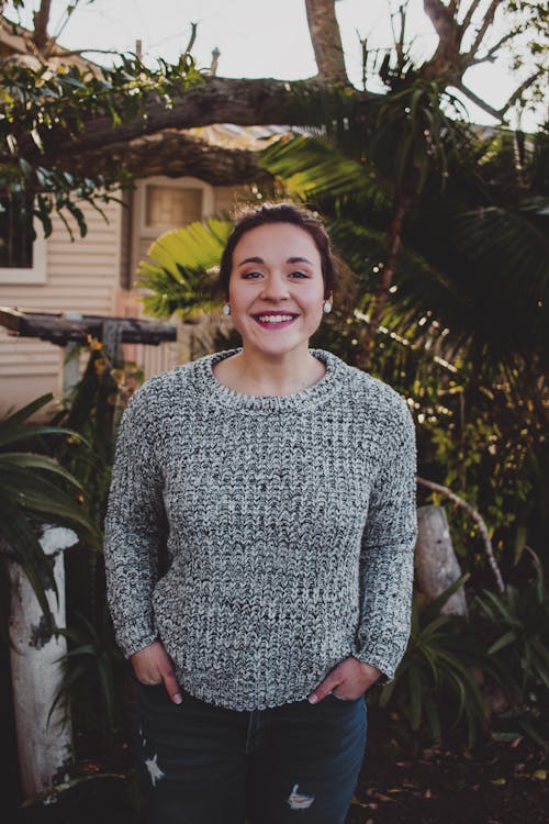 Woman in Gray Knit Sweater Smiling