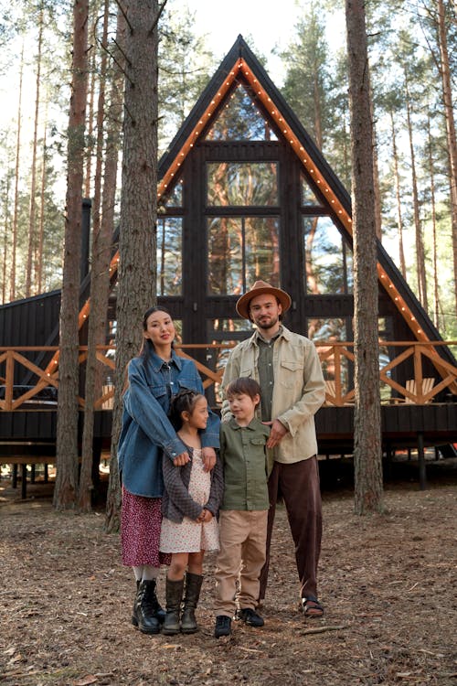 Family Posing near a Wooden Cabin