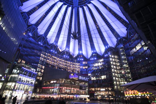 Spectacular modern complex with illuminated glass roof at night