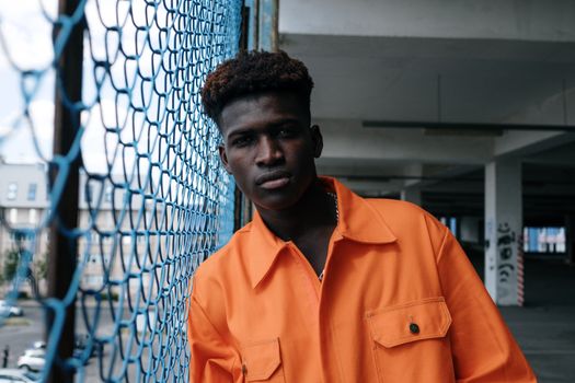 Man Posing by the Metal Fence