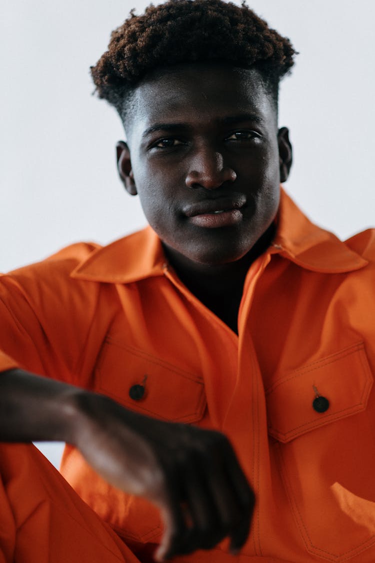 Man In Orange Clothes Smiling  