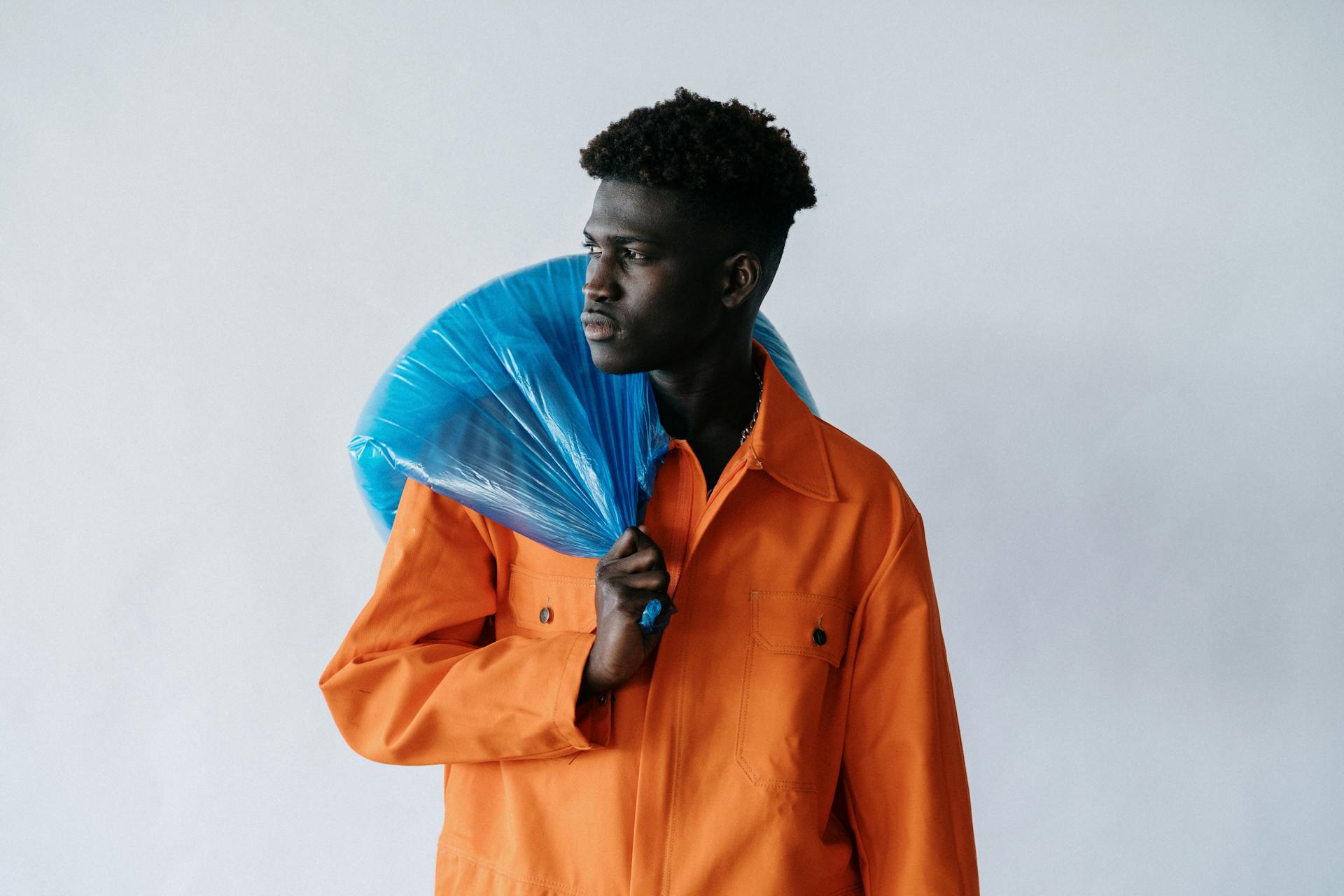 Man in Waste Collector Uniform with Garbage Bag