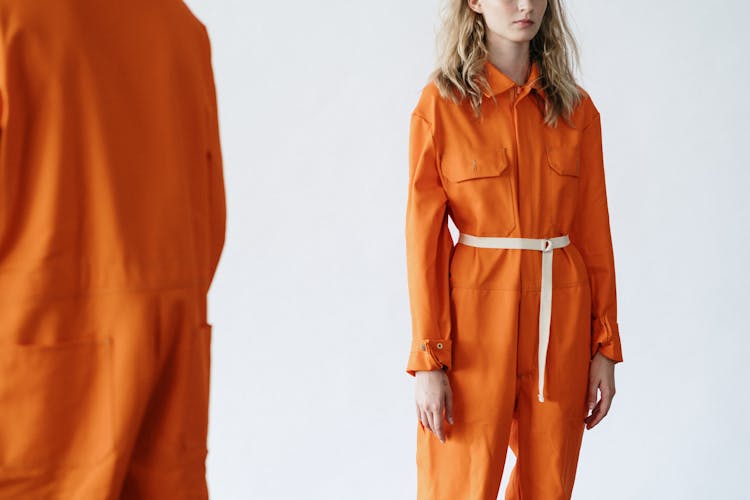 Woman In Orange Overall With White Belt