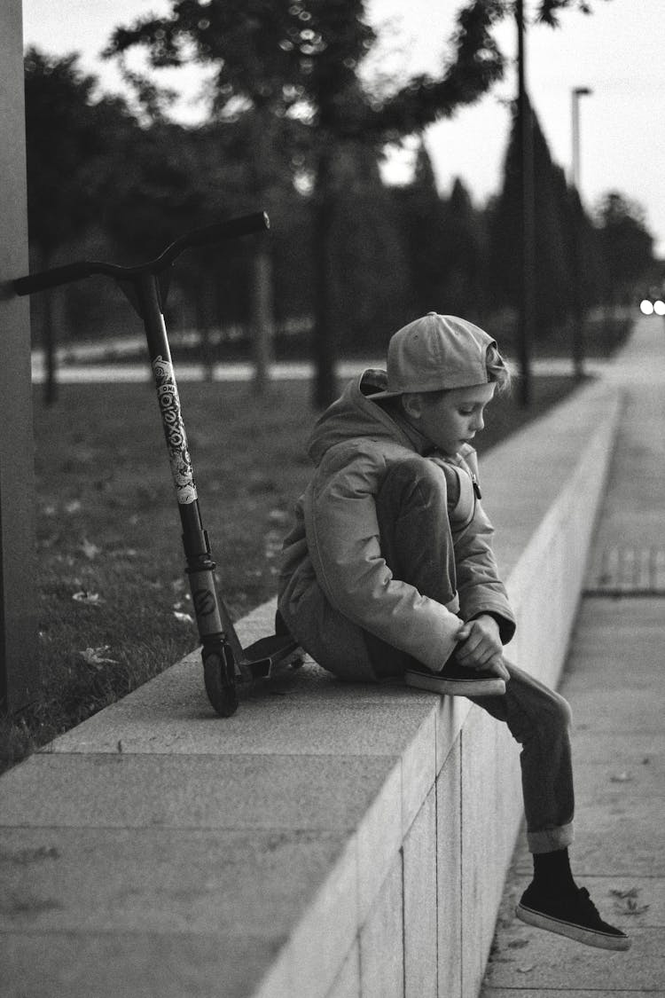 Black And White Photo Of Sad Boy Wearing Cap