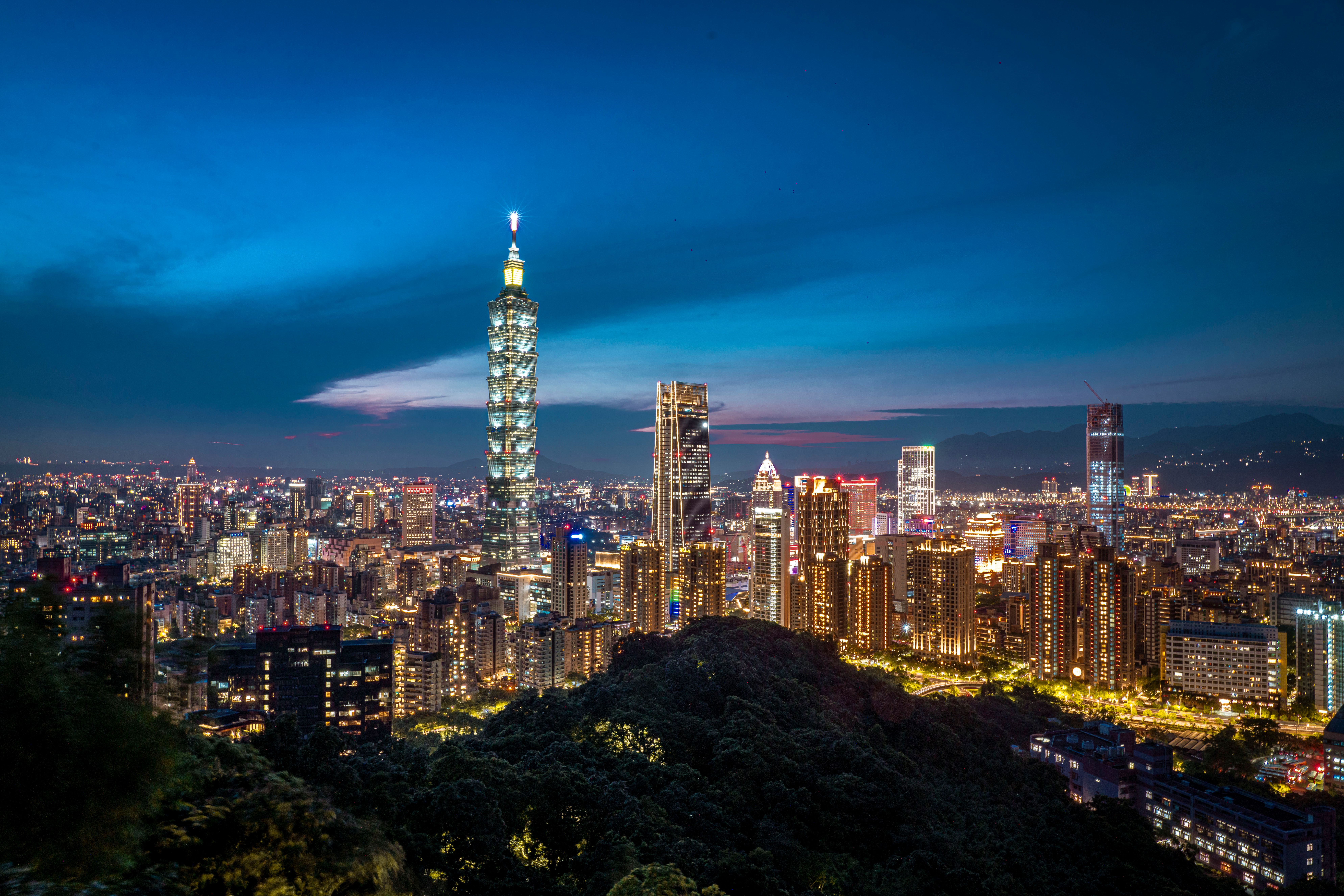 Dazzling view of Taipei skyline featuring the iconic Taipei 101 illuminated against the night sky.