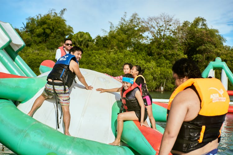 People Having Fun On Inflatable Water Game