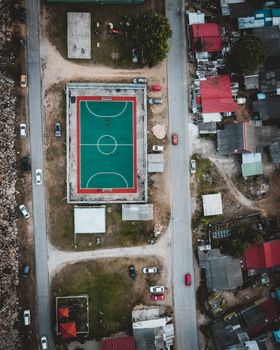 Aerial shot of a basketball court surrounded by houses in Chukai, Malaysia.