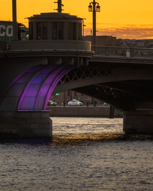 Free A captivating view of an illuminated bridge in Saint Petersburg at sunset with vibrant purple lights. Stock Photo