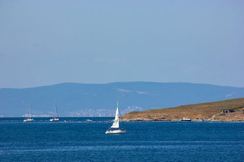 White Sail Boat on Blue Sea