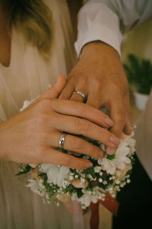 Free Hands of a Couple Wearing Wedding Rings Stock Photo