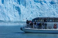 People Riding on White and Blue Boat on Sea