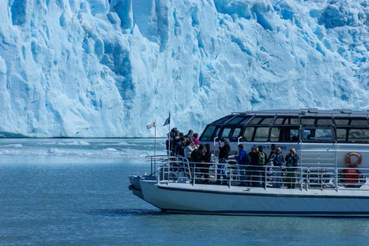 People Riding on White and Blue Boat on Sea
