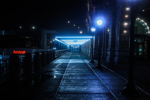 Black Outdoor Pedestal Lamp Near Coaster Train Rail