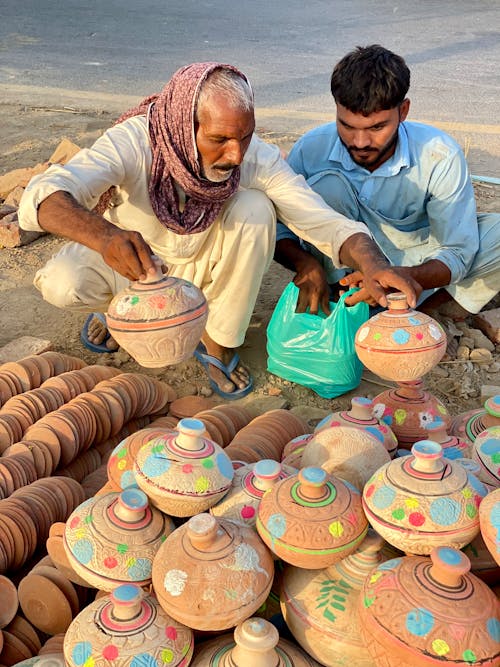 Men Selling Handmade Clay Jars Outdoors