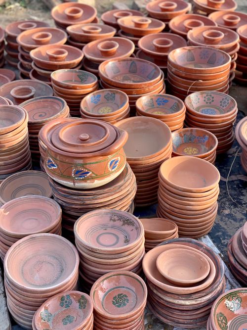 Free Explore the beauty of handmade clay pottery displayed in abundance at an outdoor market. Stock Photo