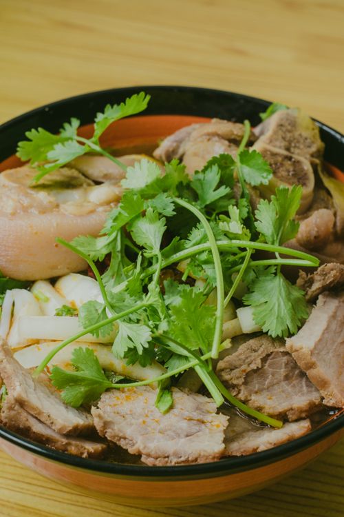 Free Savor this hearty bowl of Asian pork soup rich with fresh herbs and aromatic spices. Stock Photo